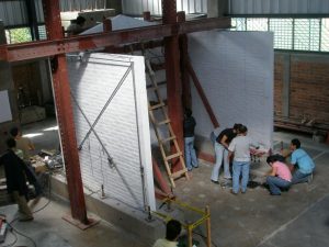 Full-scale fired clay brick masonry solid wall out-of-plane load test