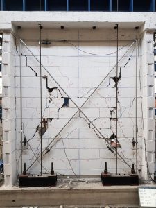 Final state of full-scale solid concrete block masonry wall, tested with load parallel to the plane