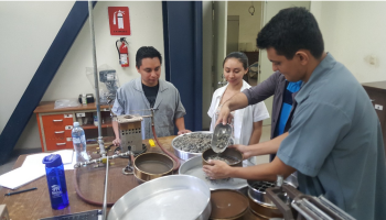 Students preparing material for wear test in Los Angeles machine